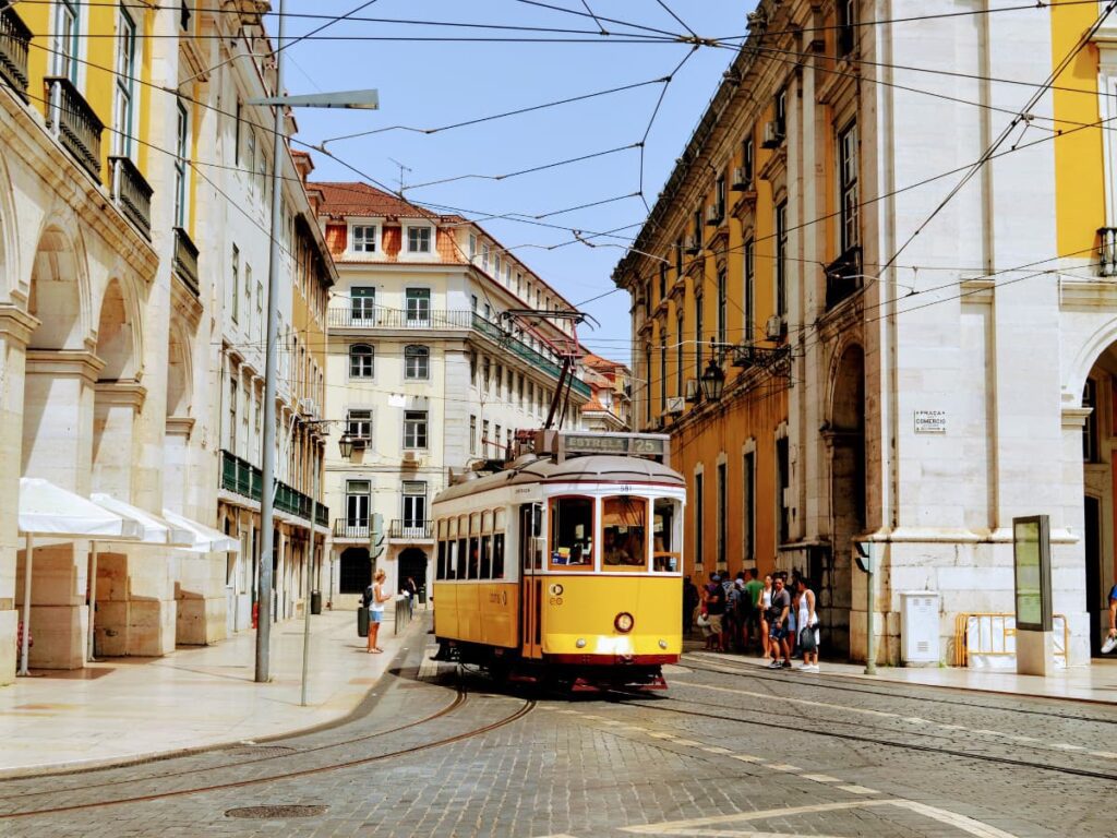 The yellow 28 tram in Praça do Comércio, Lisbon, Portugal.